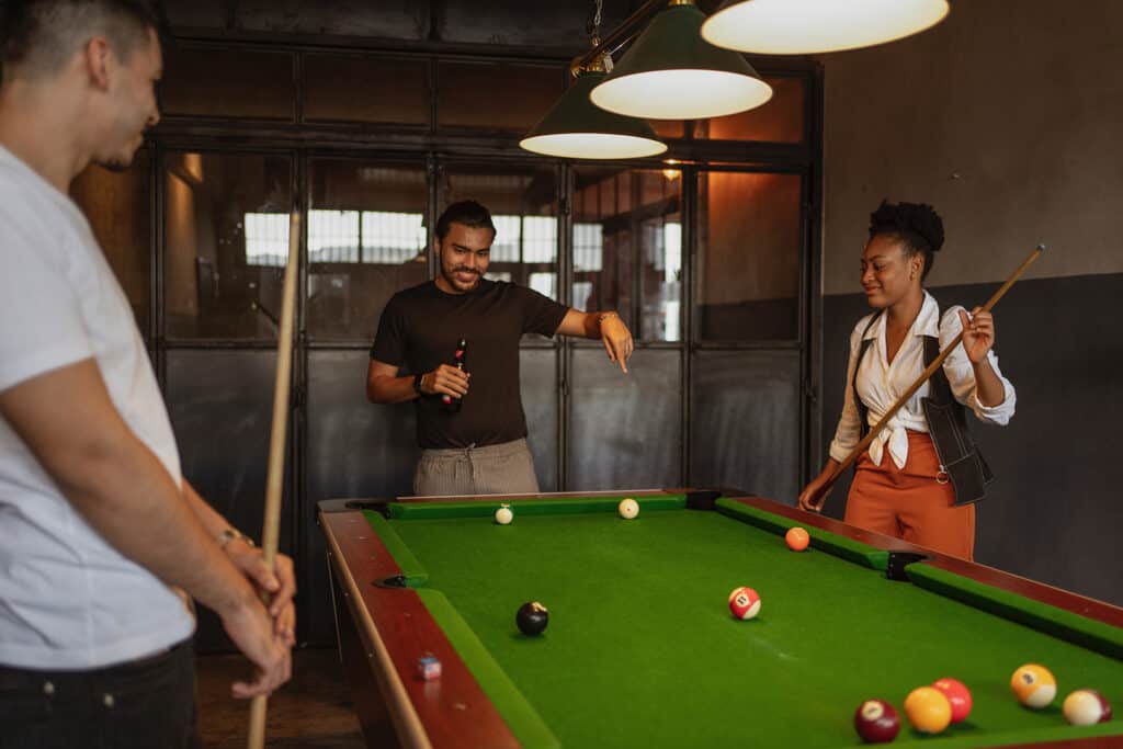 Making friends around the pool table in a hostel.